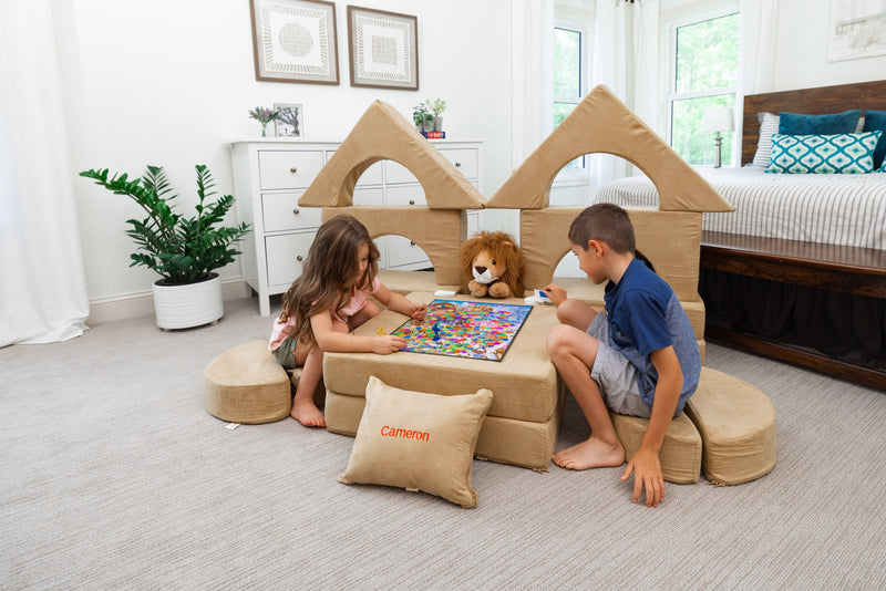 The Original Play Castle Sofa, a light grey FoamOh play couch built into a castle
